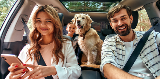 People with dog in a car